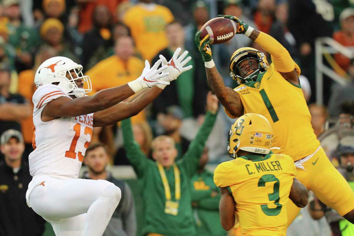 Baylor cornerback Grayland Arnold (1) intercepts a pass intended for Texas wide receiver Brennan Eagles (13) in the third quarter of an NCAA college football game Saturday, Nov. 23, 2019, in Waco, Texas. (AP Photo/Richard W. Rodriguez)