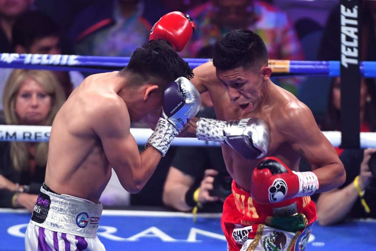 Leo Santa Cruz (L) hits Miguel Flores in the first round of their fight for a vacant WBA super featherweight title at MGM Grand Garden Arena on November 23, 2019 in Las Vegas, Nevada. Santa Cruz won by unanimous decision.