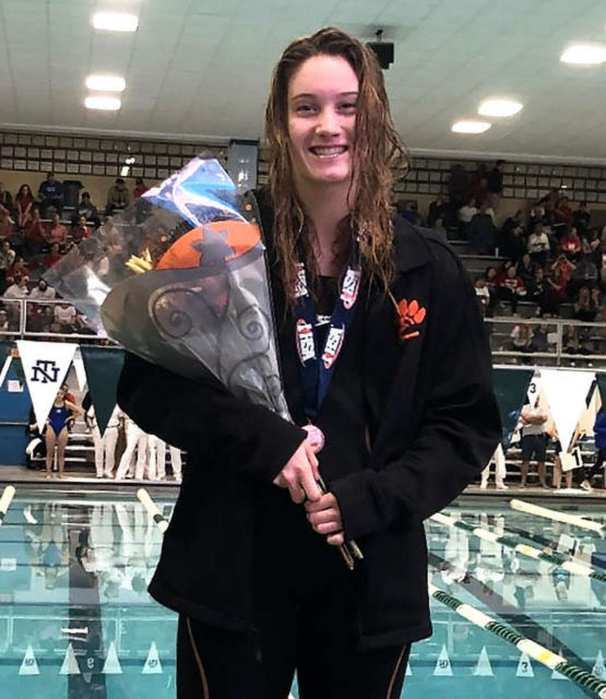 Edwardsville senior Josie Bushell poses with her medal after placing 12th in the 100-yard freestyle on Saturday in the finals of the state meet at New Trier High School.