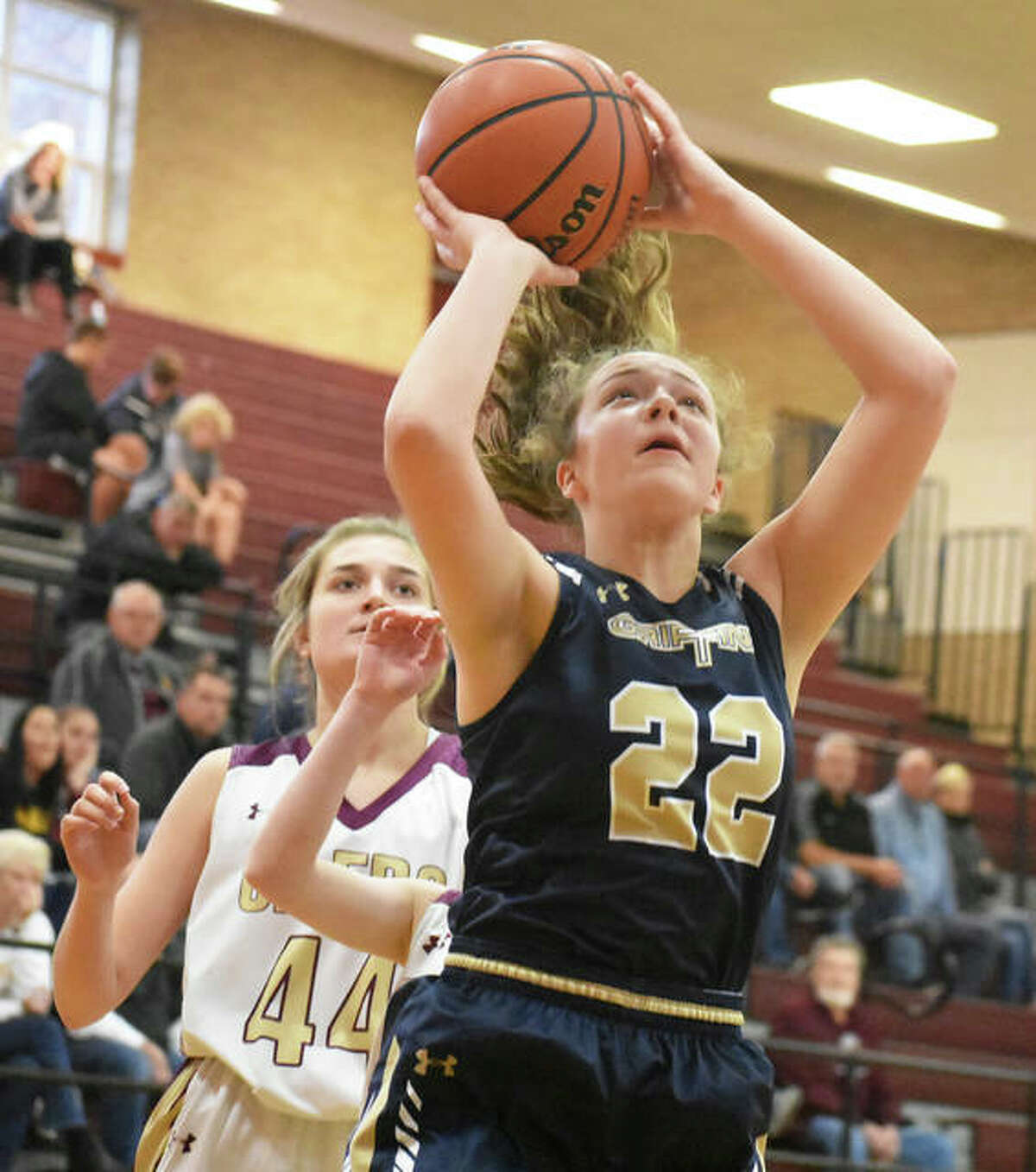 Father McGivney’s Charlize Luehmann (22) puts up a shot after getting past EA-WR’s Aubrey Robinson on Saturday at the Dupo Cat Classic.