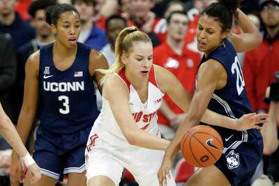 Ohio State forward Dorka Juhasz, center, works for the ball between Connecticut forwards Megan Walker, left, and Olivia Nelson-Ododa during an NCAA Women's basketball game in Columbus, Ohio, Sunday, Nov. 24, 2019.