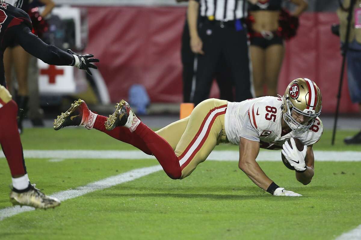 San Francisco 49ers tight end George Kittle (85) blocks Los Angeles Chargers  linebacker Amen Ogbongbemiga (57) during the first half of an NFL preseason  football game Friday, Aug. 25, 2023, in Santa