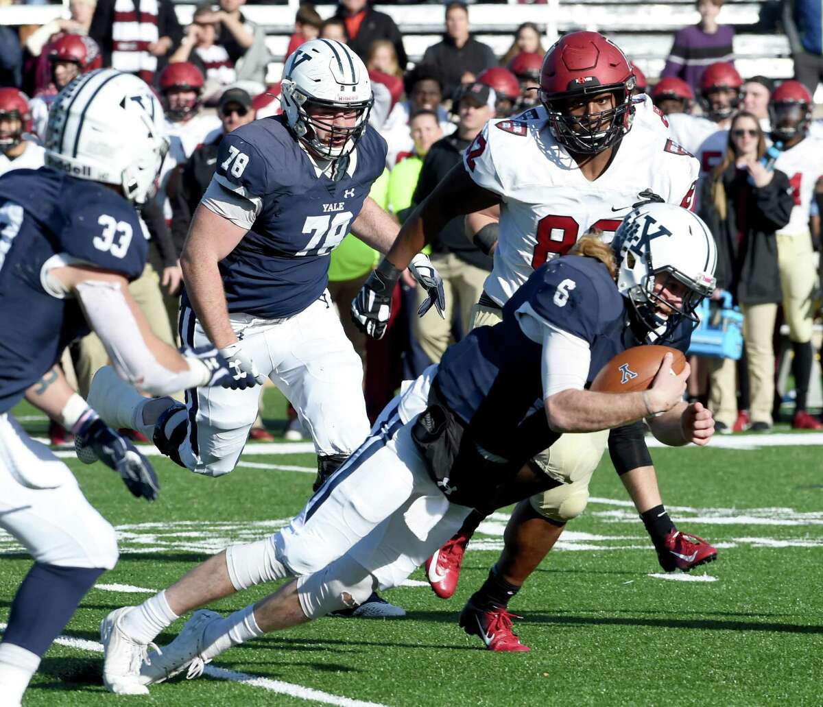 Yale quarterback Kurt Rawlings attempts to get a first down against Harvard in the first half Saturday in New Haven.