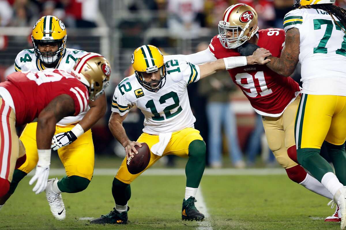 San Francisco 49ers' Arik Armstead pressures Green Bay Packers' Aaron Rodgers before Rodgers fumbled in 1st quarter during NFL game at Levi's Stadium in Santa Clara, Calif., on Sunday, November 24, 2019.