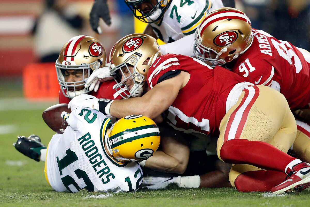 San Francisco 49ers' Nick Bosa, Fred Warner and Arik Armstead force fumble by Green Bay Packers' Aaron Rodgers in 1st quarter during NFL game at Levi's Stadium in Santa Clara, Calif., on Sunday, November 24, 2019.