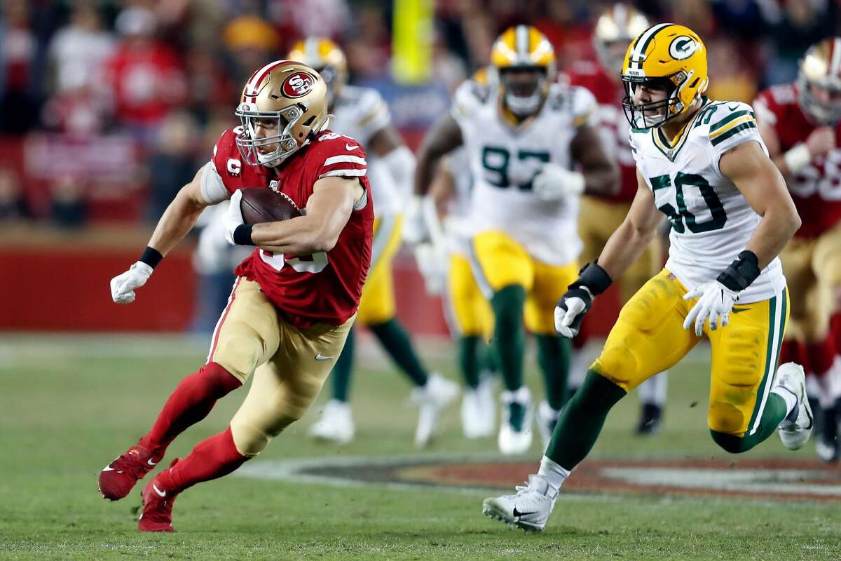 San Francisco 49ers' George Kittle runs after a catch against Green Bay Packers' Blake Martinez during NFL game at Levi's Stadium in Santa Clara, Calif., on Sunday, November 24, 2019.