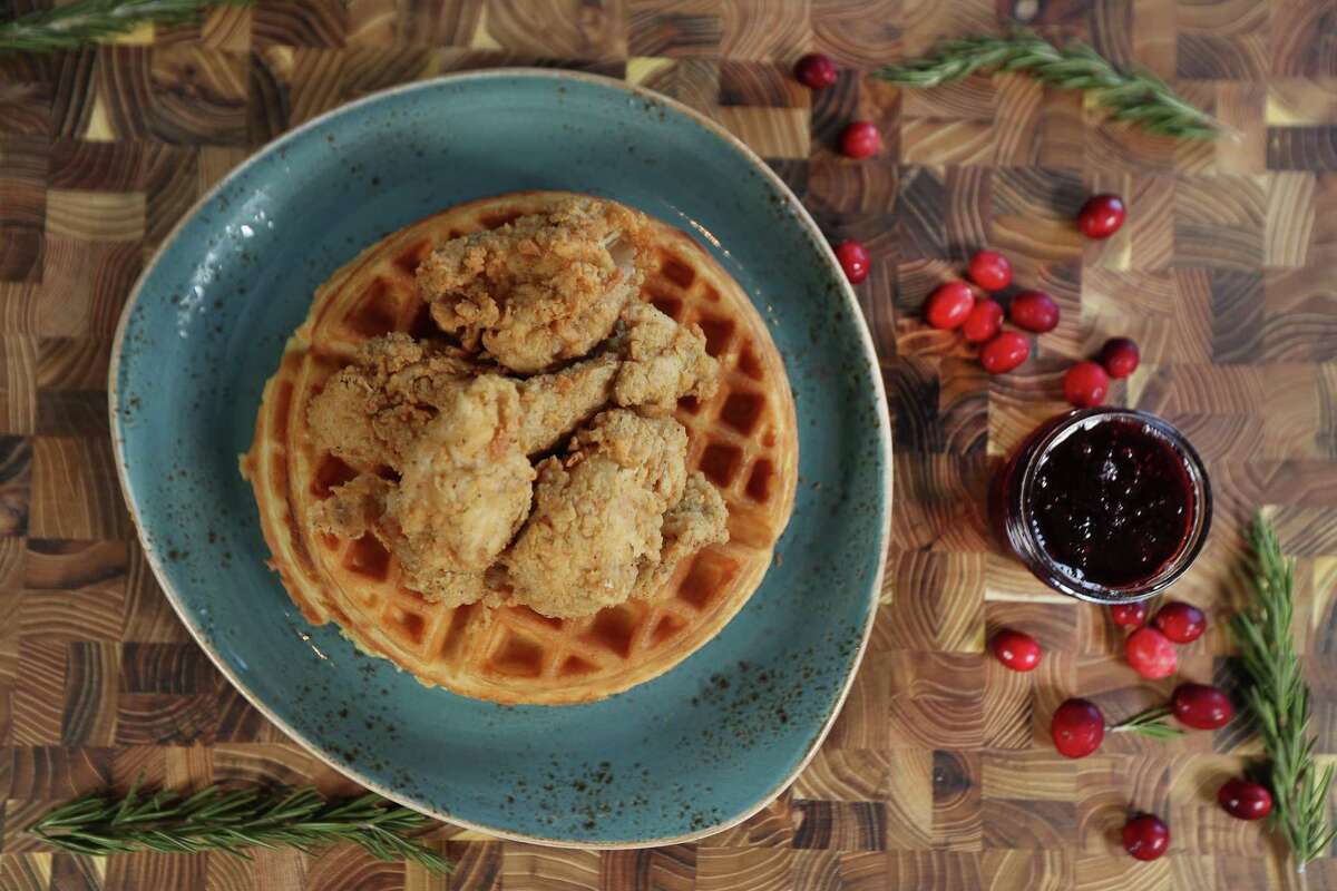 Leftover turkey gets country fried and placed on top of waffles with cranberry maple syrup in this unique day-after-Thanksgiving recipe.