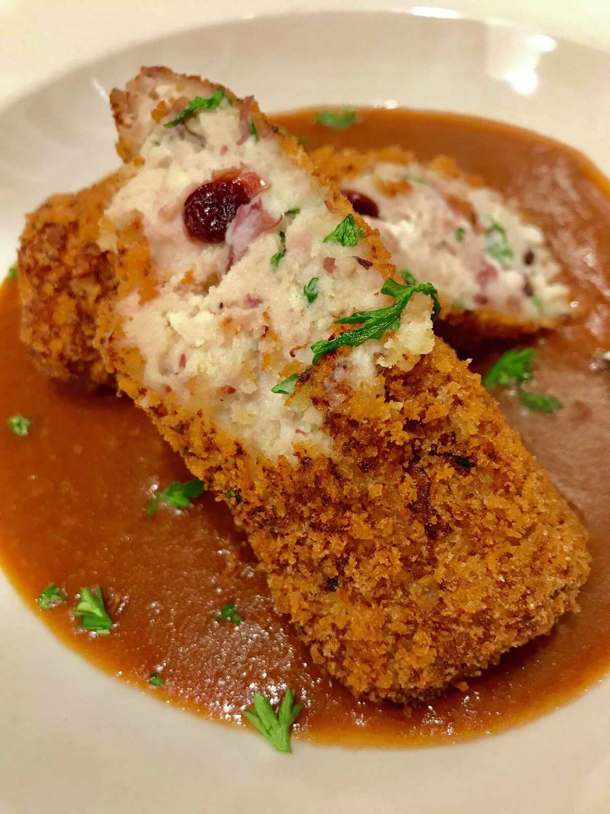 Leftover turkey, mashed potatoes and cranberries are turned into croquettes bathed with leftover gravy.