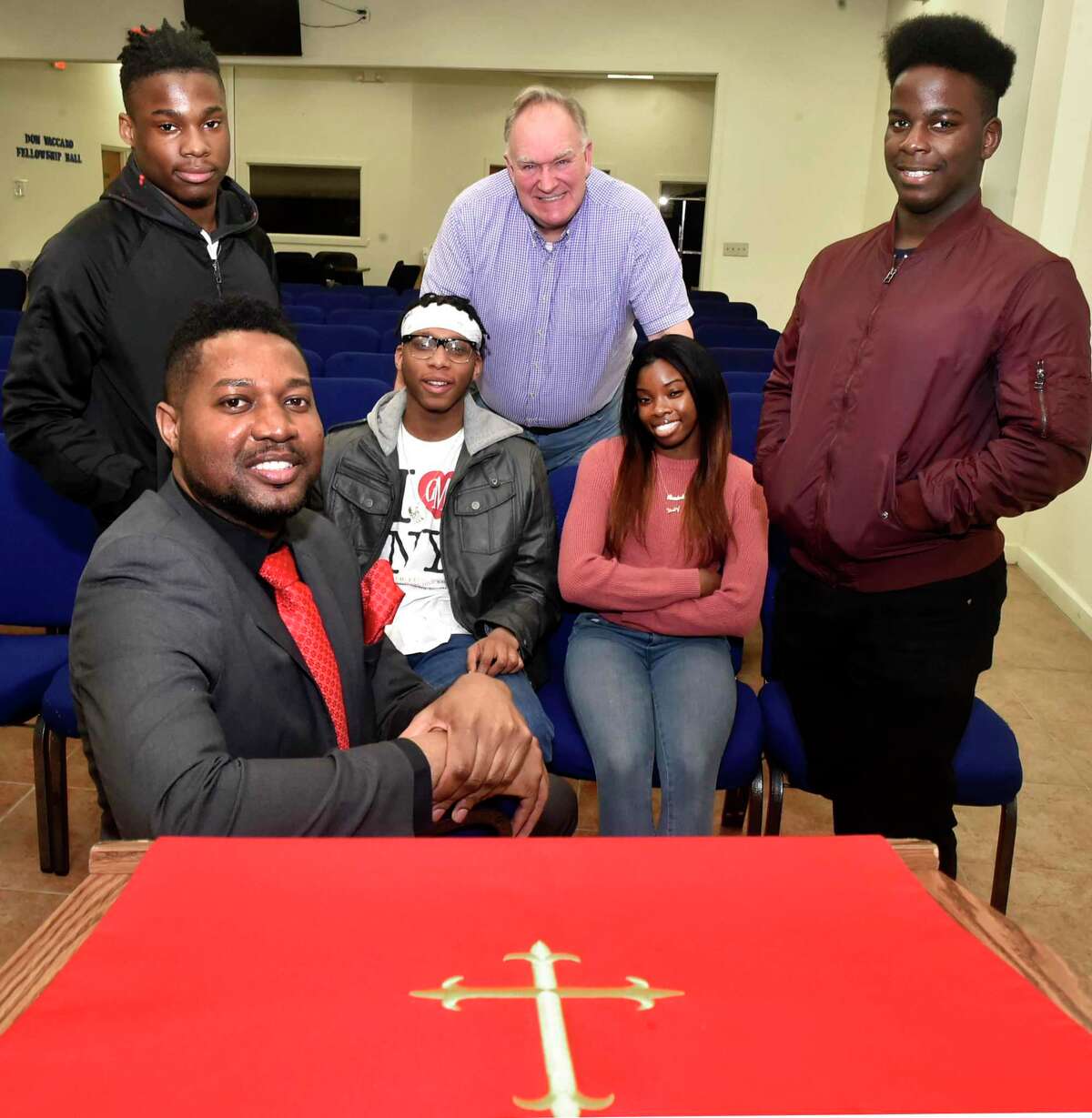 Reverend Herron Gaston, Yale Divinity School Associate Director of Admissions and Recruitment and Senior Pastor at Summerfield United Methodist Church in Bridgeport, sitting front, who organized Youth With A Purpose, sitting with participants.