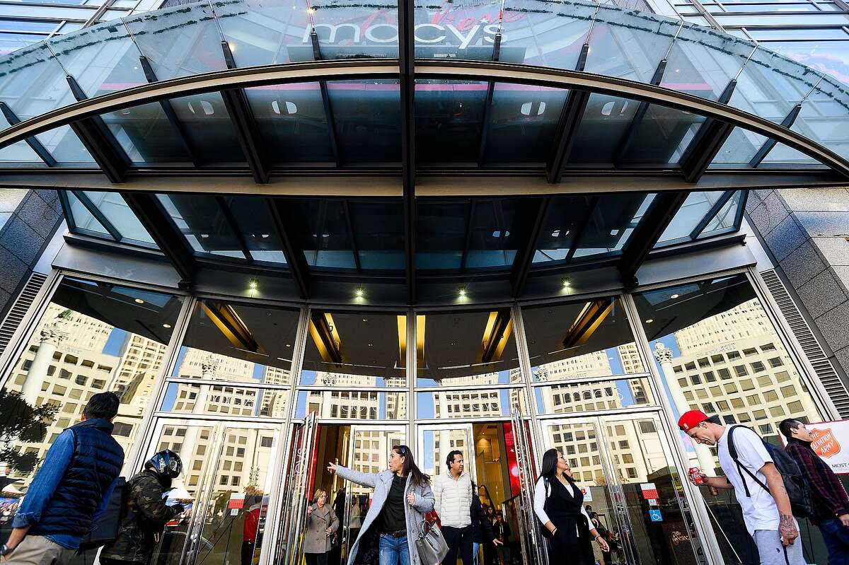 Shoppers leave Macy's Union Square store on Monday, Nov. 25, 2019, in San Francisco.