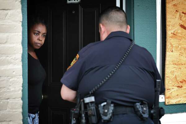 Prado serves an eviction citation to Patrice Daniels at Cottage Creek Apartments on the Northeast Side.