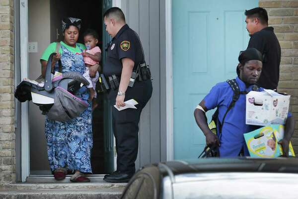 Bexar County Deputy Constable Edward Prado of Precinct 4 stands by as cohabitants of Patricia White leave White’s apartment after she is served a writ of possession at Brooks Townhomes on Wednesday, Nov. 6, 2019. City Council XX a proposal to give renters 60 days to come up with rent if they’re short during the COVID-19 crisis. Landlords would have to tell renters at least two months in advance that they plan to evict them for not paying.