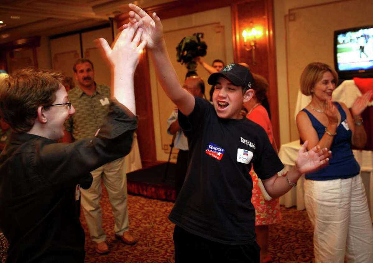 Ted Lopatin, 18, left of Greenwich, and Aaron Gaberman, 15 of Weston, supporters of Republican candidate Dan Debicella, high five as they listen to the primary election returns for the fourth congresional district. Debicella supporters gathered at the Norwalk Inn on Tuesday night, August 10, 2010.