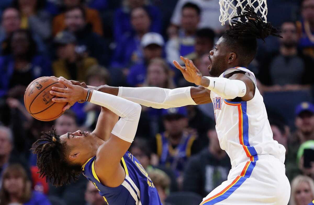 Golden State Warriors' Jordan Poole has his shot bloc led by Oklahoma City Thunder's Nerlens Noel in 4th quarter of Thunder's 100-97 win in NBA game at Chase Center in San Francisco, Calif., on Monday, November 25, 2019.