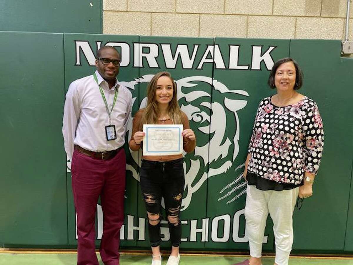 Norwalk High School Principal Reginald Roberts, first-place essay contest winner Tabitha Baker and school counselor Yvonne Berrios.