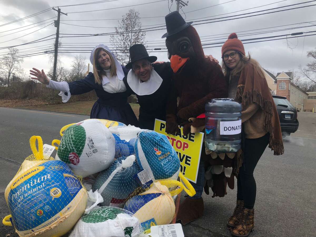 Dr. Bruce Sofferman, owner of Smile Dental Center, his wife, Deborah, left, and daughter Sophia, right, along with quite an enthusiastic turkey collected donations for Spooner House on Wednesday outside his office’s location at 1000 Bridgeport Avenue.
