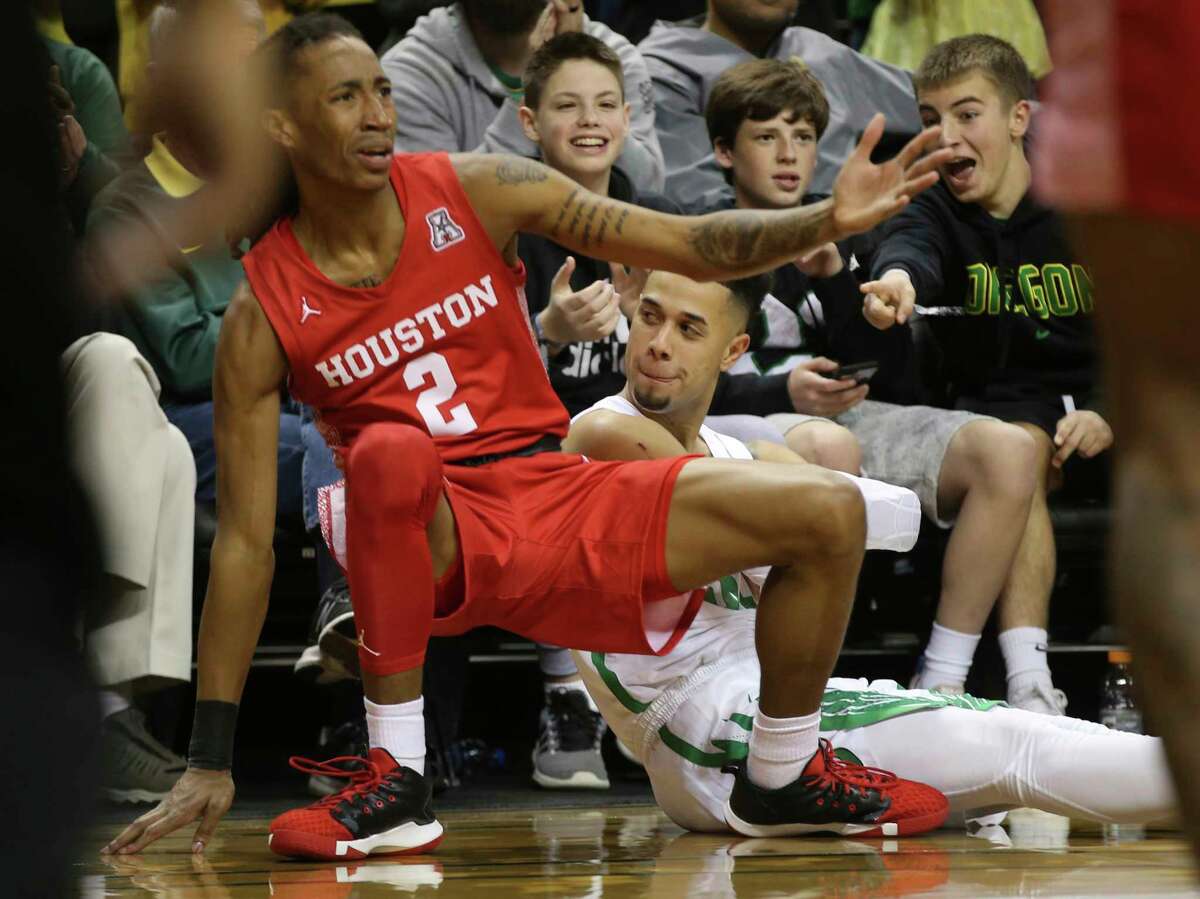 Houston's Caleb Mills, left, protests a call as Oregon's Anthony Mathis looks over after shooting a 3-pointer and getting the foul call during the second half of an NCAA college basketball game in Eugene, Ore., Friday, Nov. 22, 2019. (AP Photo/Chris Pietsch)
