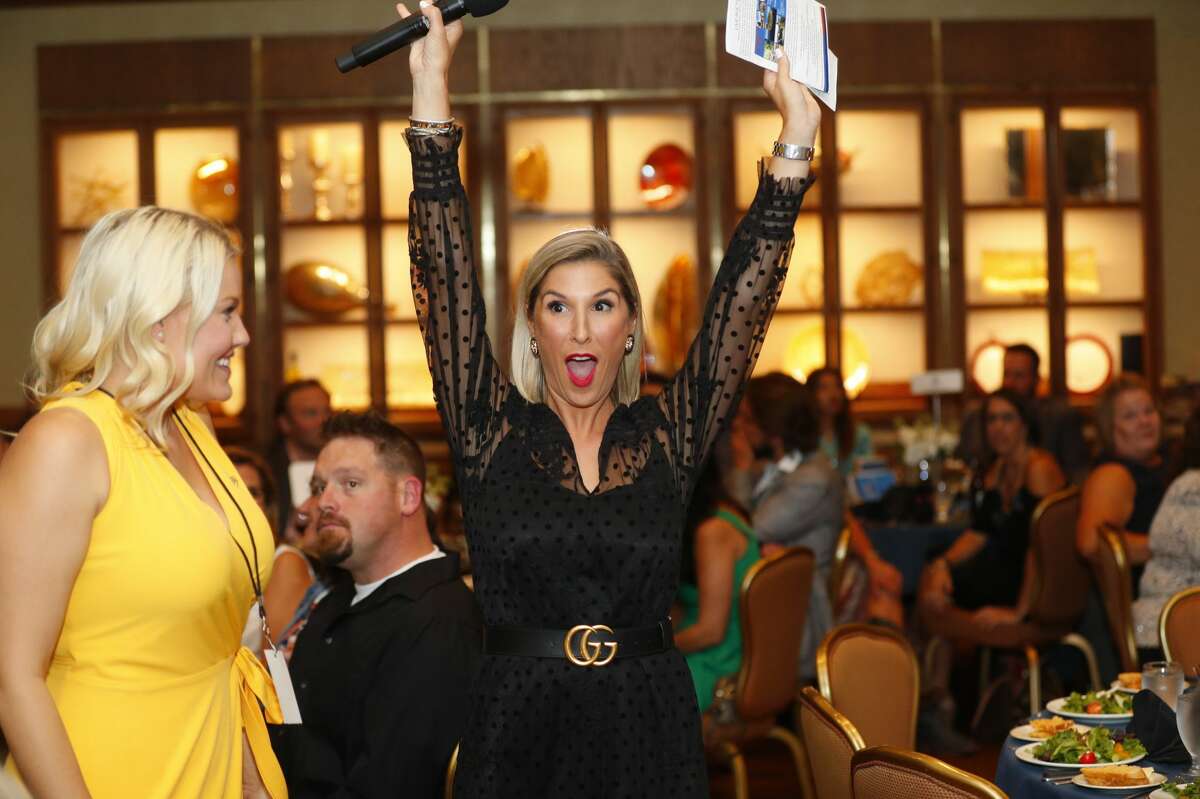 Brittany Hebert, CEO of Sky High, reacts as a live auction item sells during Sky High for Kids banquet Sept. 20 at the Petroleum Club.