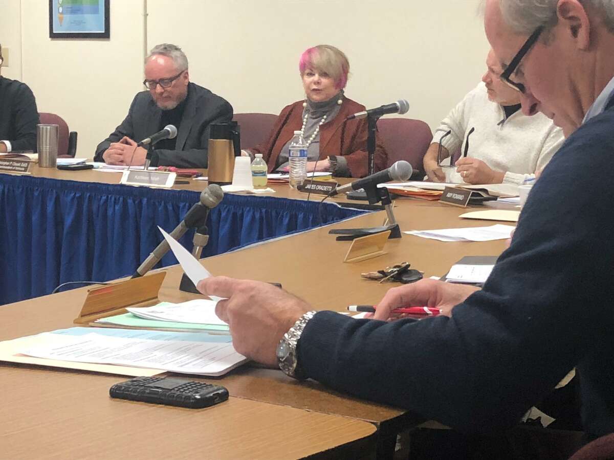 Board of Education Chairman Kathy Yolish speaks during the board meeting Monday, as school Superintendent Chris Clouet, left, and board Vice Chairman James Orazietti, right, look on. Board member John Fitzgerald is in the foreground, inspecting legal fee documents distributed during the meeting.