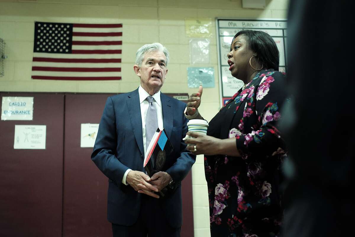 Federal Reserve Board Chair Jerome Powell, left, speaks with Jannel Satterwhite, a community relations director for a property management company, Monday, Nov. 25, 2019, during a visit to East Hartford, Conn. Powell and Eric Rosengren, president of Boston Federal Reserve Bank, visited a working-class neighborhood in East Hartford and met with residents to get a closer look at their challenges.