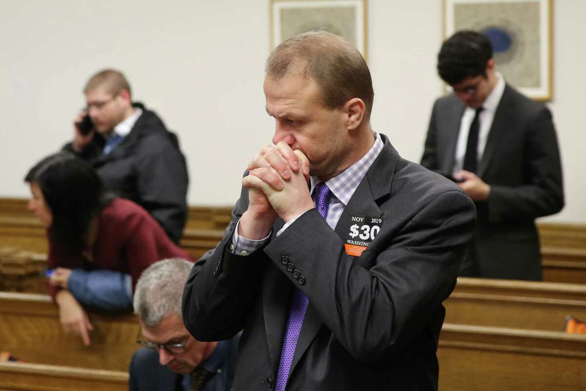 Tim Eyman stands during a break in the hearing where a coalition of counties, transportation agencies and the city of Seattle argued in front of a King County Superior Court judge for a motion to block Eyman's Initiative 976 from taking effect Dec. 5, saying there would be irreparable harm, that it was unconstitutional and violated the single-subject rule, Tuesday, Nov. 26, 2019.