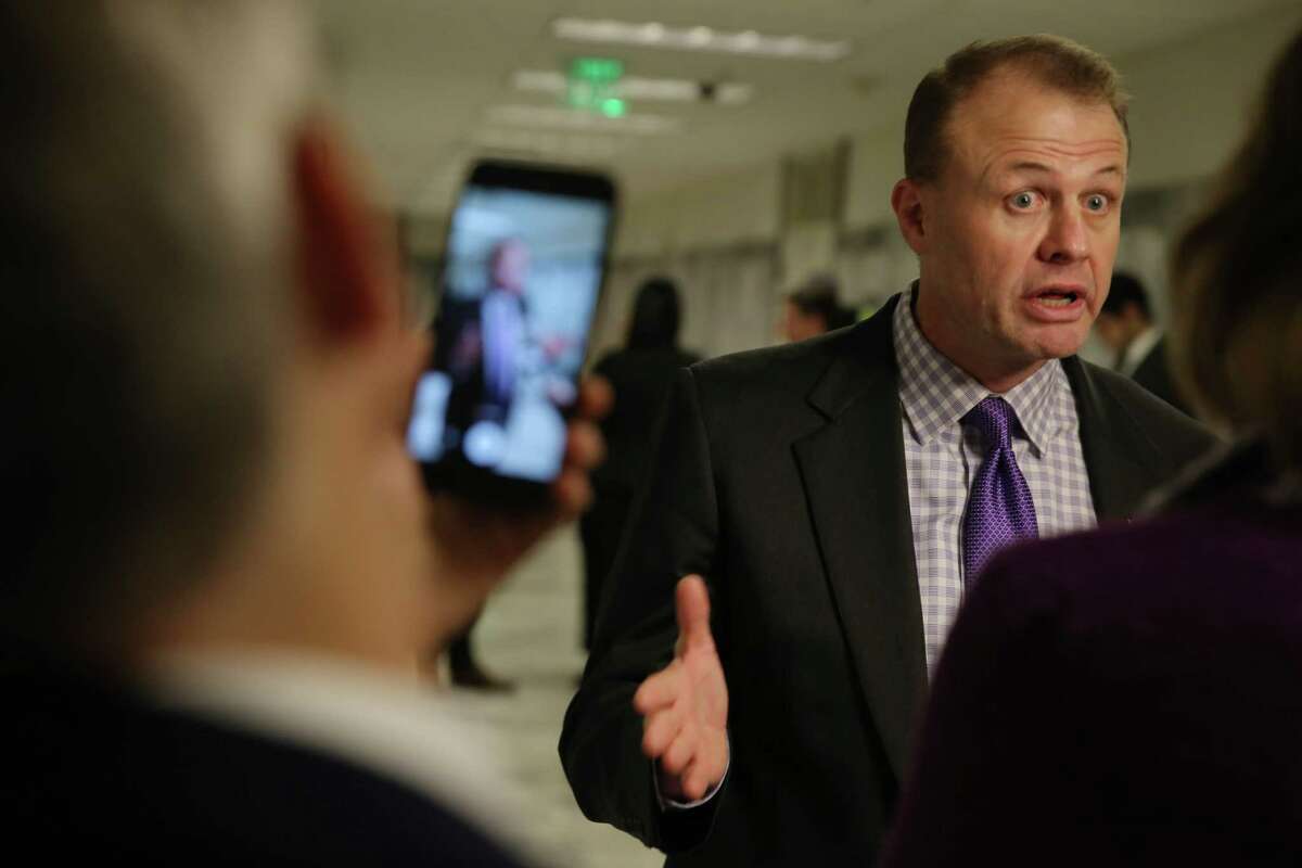 Tim Eyman speaks to media outside the courtroom during a hearing where a coalition of counties, transportation agencies and the city of Seattle argued in front of a King County Superior Court judge for a motion to block Eyman's Initiative 976 from taking effect Dec. 5, saying there would be irreparable harm, that it was unconstitutional and violated the single-subject rule, Tuesday, Nov. 26, 2019.