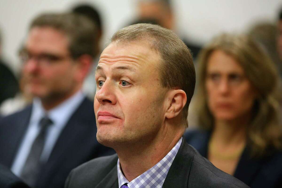 Tim Eyman, right, listens to arguments during a hearing where a coalition of counties, transportation agencies and the city of Seattle argued in front of a King County Superior Court judge for a motion to block Eyman's Initiative 976 from taking effect Dec. 5, saying there would be irreparable harm, that it was unconstitutional and violated the single-subject rule, Tuesday, Nov. 26, 2019.