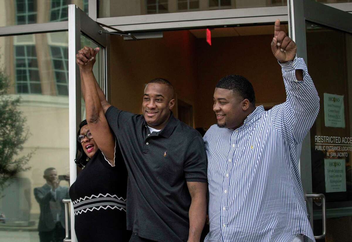 Lydell Grant, center, his mother Donna Poe, left, and brother Alonzo Poe celebrate Grant's release on bond on Tuesday, Nov. 26, 2019, in Houston. Earlier in the day, Grant was ordered released on bond after prosecutors and defense attorneys with the Innocence Project of Texas agreed that Grant should be released while the case is investigated further in light of new DNA evidence. Grant was convicted of capital murder in the 2010 stabbing death of Aaron Scheerhoorn outside of a Montrose bar, and he had spent seven years behind bars.