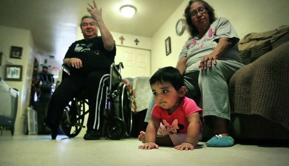 Teresa and Joe Garcia are raising their granddaughters in their apartment, but they were almost evicted this summer. Ashley Marie is starting to crawl. / ©2019 San Antonio Express-News
