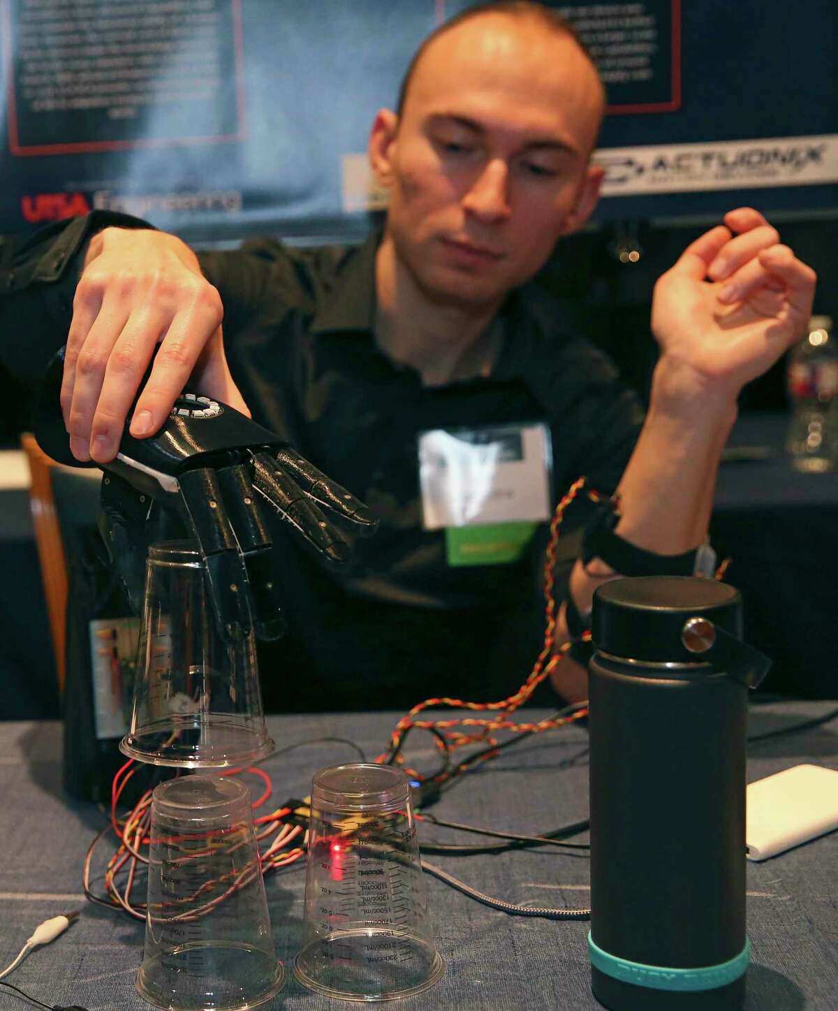 Ryan Saavedra, 26 of San Antonio, demonstrates the Globally Available Robotic Arm at the University of Texas at San Antonio Fall 2019 Tech Symposium on Tuesday. Saavedra and fellow senior engineering students Ruairidh McWilliam, Evan Jenkins, and Max Brecheisen designed and built the low-cost bionic hand for below-elbow amputees.