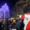 Santa Claus (Stamford resident Thomas Patterson) points and magically the lights sparkle as the tree lights up to the joys and cheers of children and families attending the Jackie Robinson Park of Fame's 25th Annual Christmas Tree Lighting on Nov. 26, 2019 in Stamford, Connecticut. Several West side residents, community leaders enjoy the holiday festivity that included musical selections performed by children of Project Music, holiday treats and hot chocolate and a visit by Santa Claus.