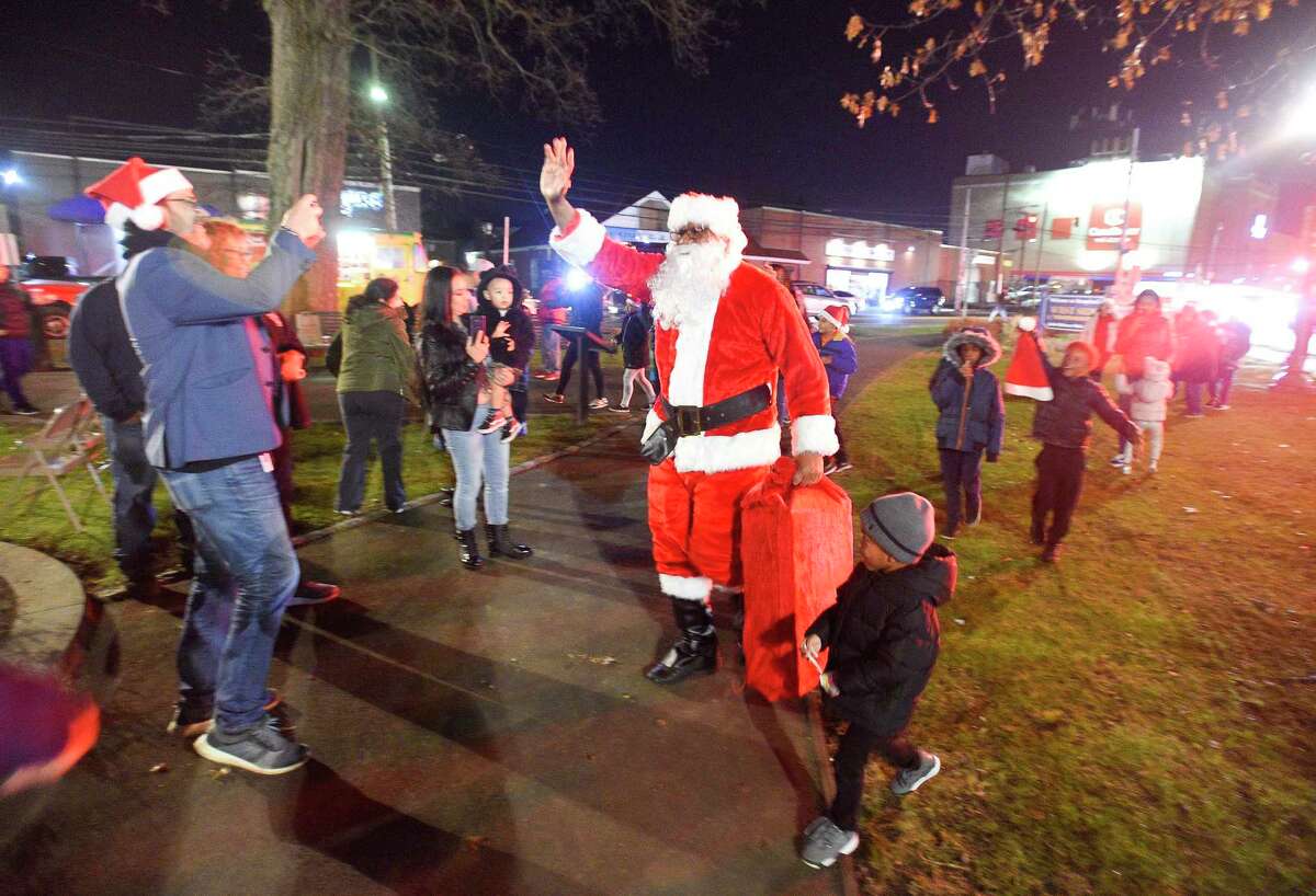 Santa Claus (Stamford resident Thomas Patterson) arrives with a bag full of treats as he is escorted by joys and cheers of children and families attending the Jackie Robinson Park of Fame's 25th Annual Christmas Tree Lighting on Nov. 26, 2019 in Stamford, Connecticut. Several West side residents, community leaders enjoy the holiday festivity that included musical selections performed by children of Project Music, holiday treats and hot chocolate and a visit by Santa Claus.