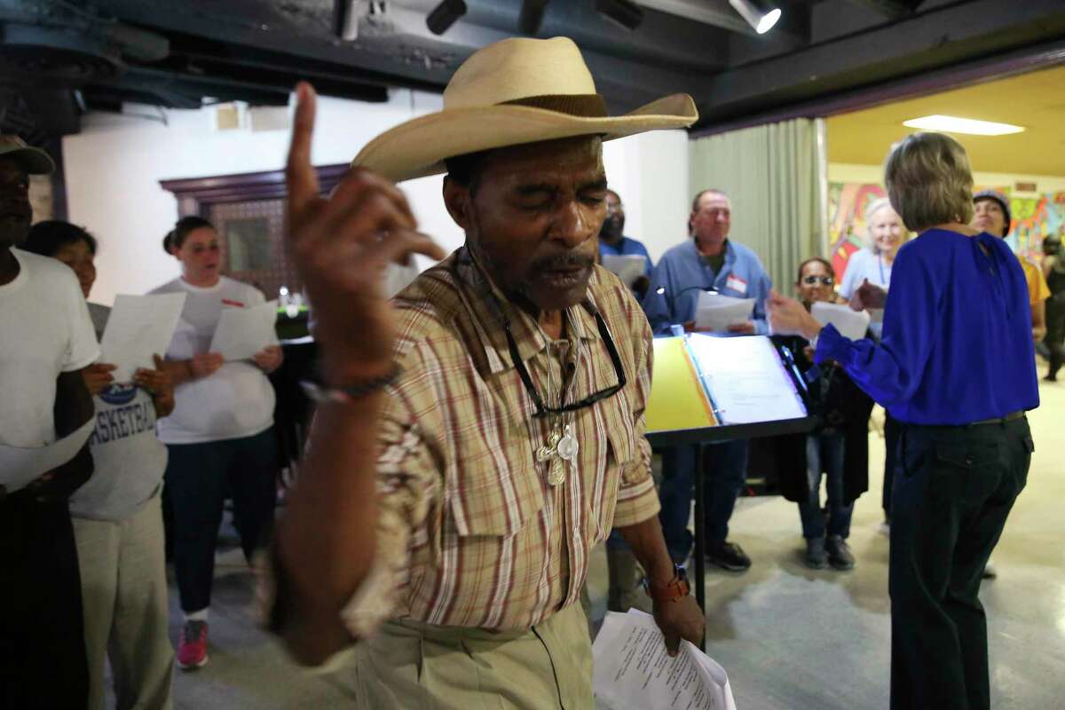 James Brown leads the Alamo City Street Choir during a short concert at Travis Park United Methodist Church, Wednesday, Oct. 23, 2019. The choir is made up of mostly homeless people.