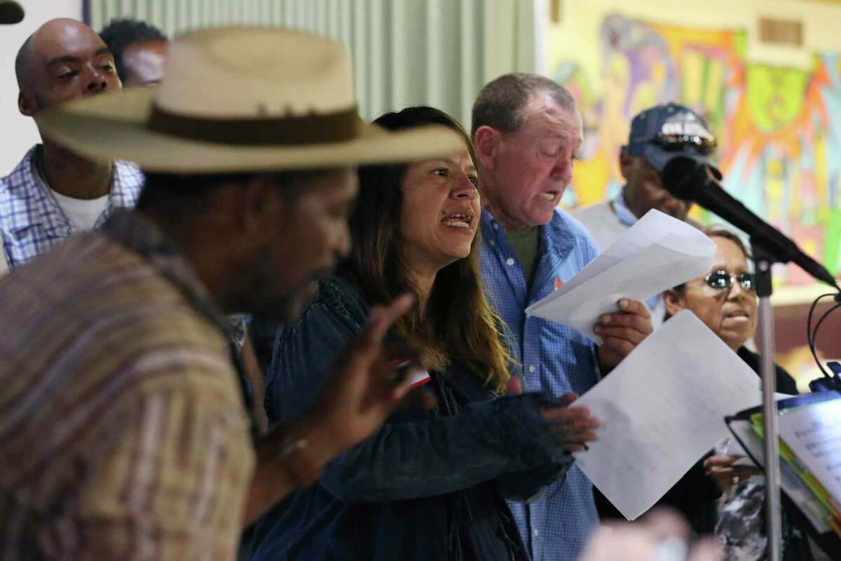 Patricia Solis, center, and Gene Schafer sing with the Alamo City Street Choir during a short concert at Travis Park United Methodist Church, Wednesday, Oct. 23, 2019. The choir is made up of mostly homeless people.