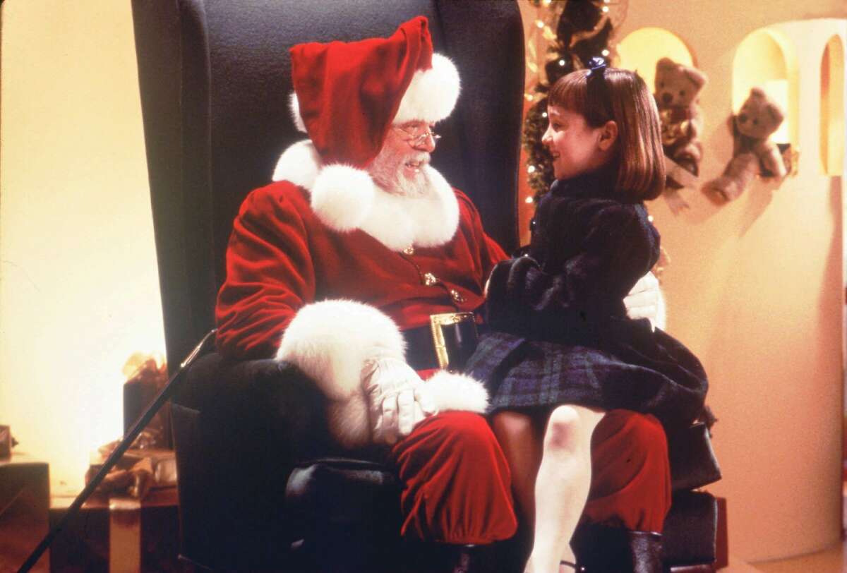 Kris Kringle (Richard Attenborough, L) fulfills the Christmas wishes of Susan Walker (Mara Wilson) in 'Miracle on 35th Street.'