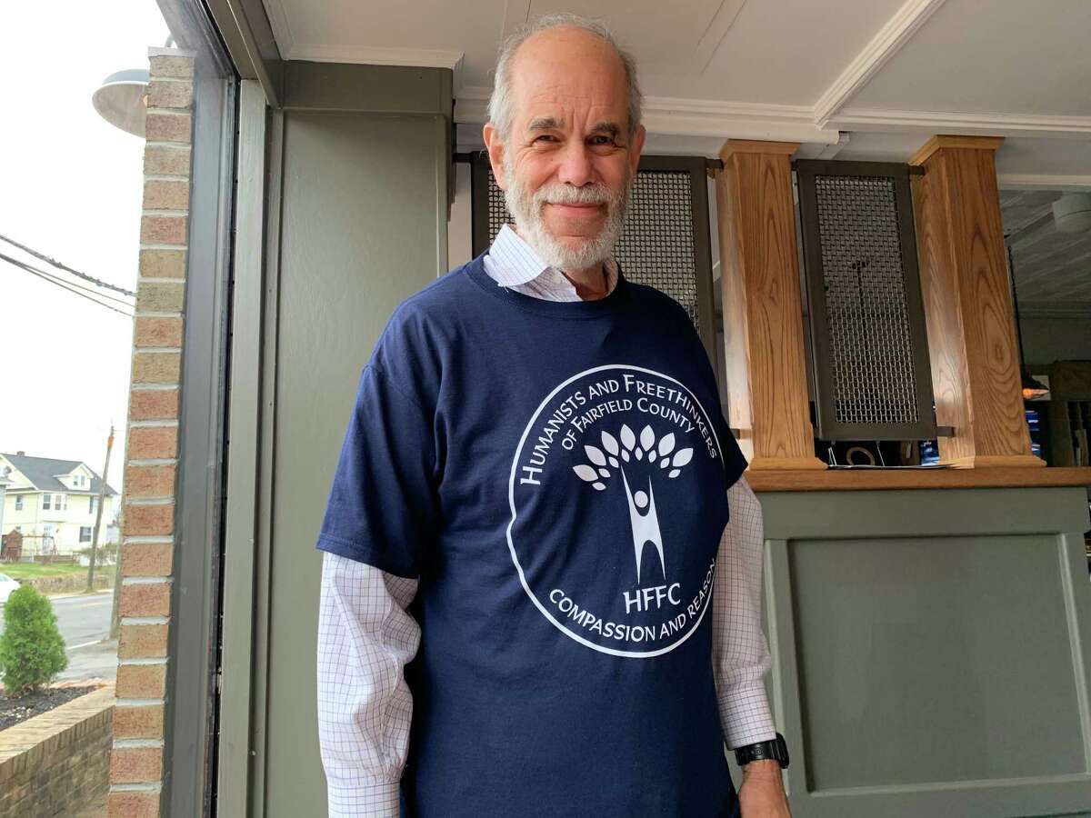 Cary Shaw shows the new Humanists of Fairfield County t-shirt.