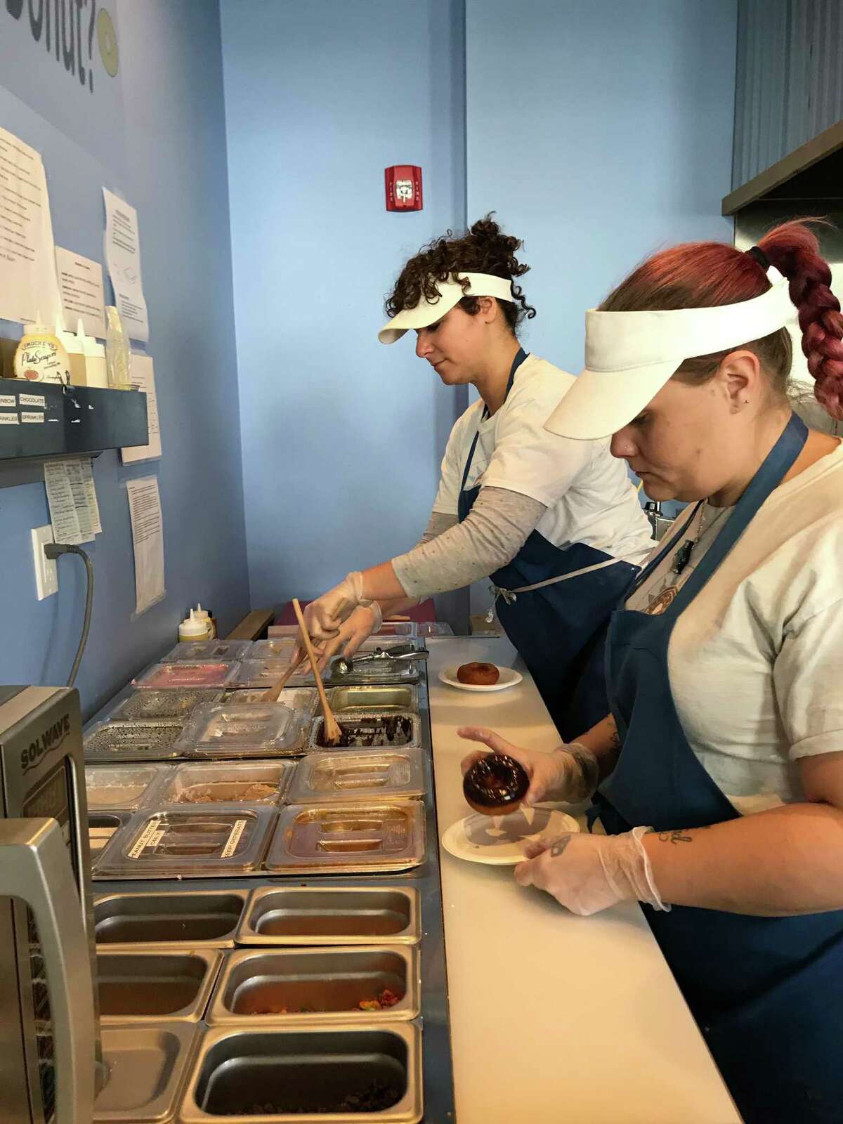 Blazing Fresh Donuts staff work to create some sweet treats at the Guilford store on Nov. 26, 2019.