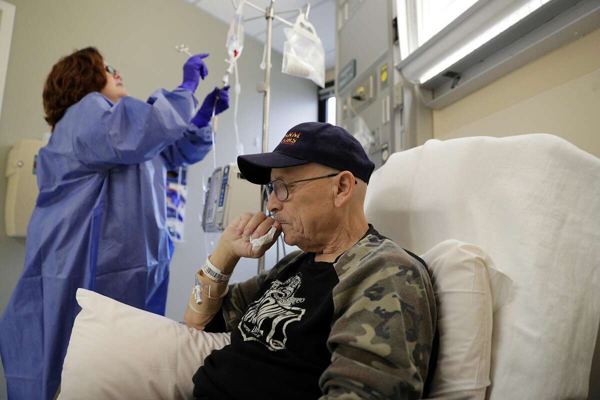 Jack Hendrix, a cancer survivor, a recipient of the Chronicle�s Season of Sharing fund, has his medication adjusted by nurse Penny Hill as he undergoes his chemotherapy treatment at Queen of the Valley Medical Center in Napa, Calif., on Thursday, November 11/14/19, 2019. When Hendrix found out he had cancer, he had surgery right away, but when his landlord found out, he was evicted from his apartment. Hendrix used the Season of Sharing fund to get housing that allowed him to continue his cancer treatments.