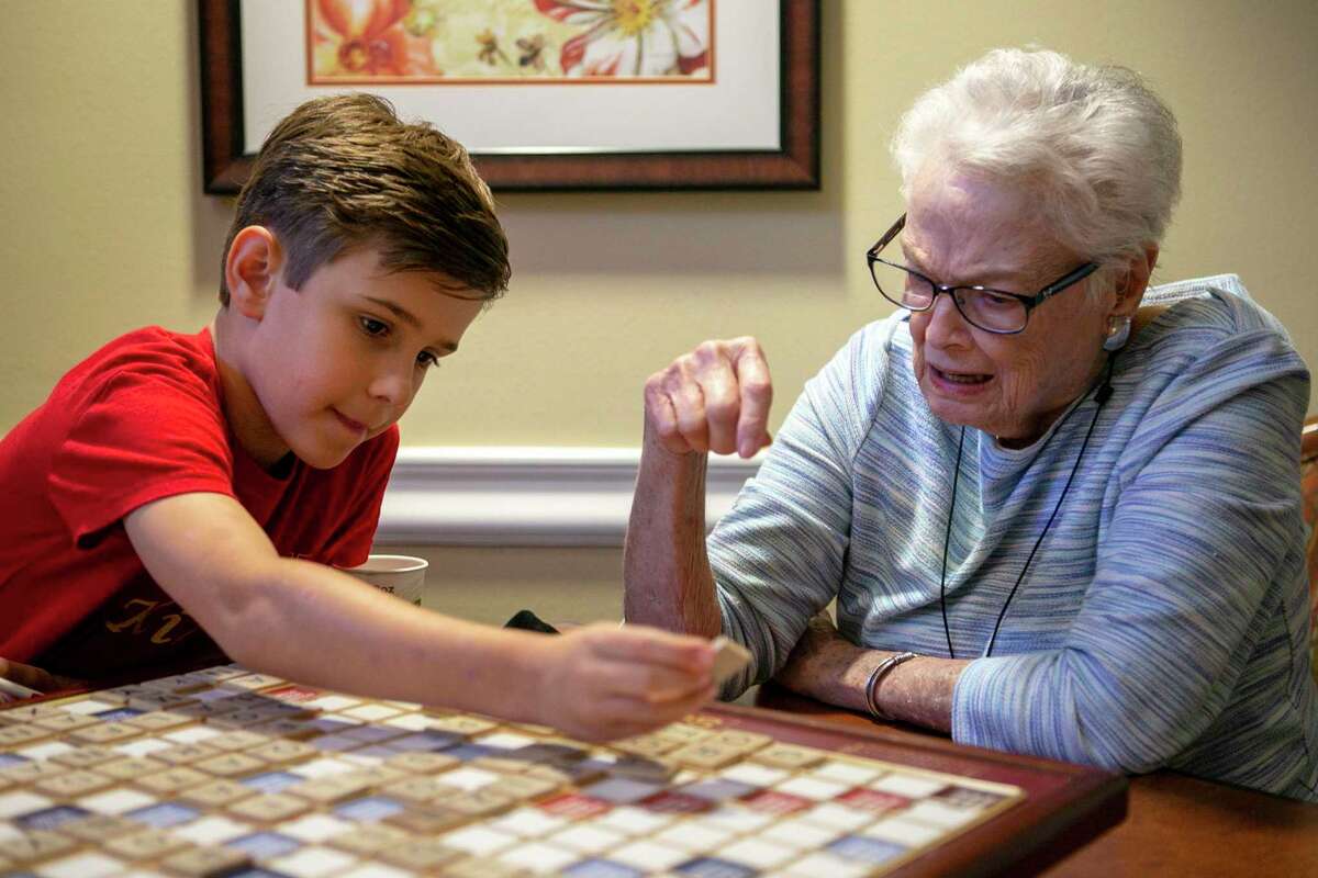 Ricky Rodriguez, 10, helps Pat Griffith, 86, play a word Sunday during their weekly Scrabble match at Brookdale Shavano Park, her assisted living center. Pat Griffith and Ricky socialize and play every Sunday. Ricky will be competing in the World English Language Scrabble Players Association youth cup in Malaysia this weekend.