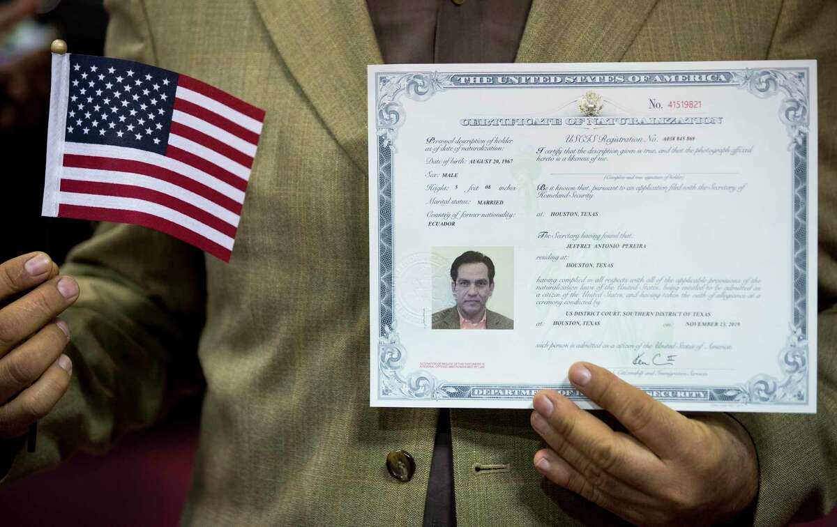 Jeffrey Antonio Pereira, a native of Equador, shows off his certificate of naturalization following a naturalization ceremony for more than 2,500 new citizens at the M.O. Campbell Educational Center on Wednesday, Nov. 13, 2019, in Houston. As the state gears up for what could be its most important election in decades, thousands of would-be voters are caught in limbo, stuck in a deep and growing backlog of immigrants applying for U.S. citizenship. While the Trump administration says it is devoting resources to cut down on the backlog, and attorneys in Houston say immigrations officials do appear to be making an effort to get more applications through.