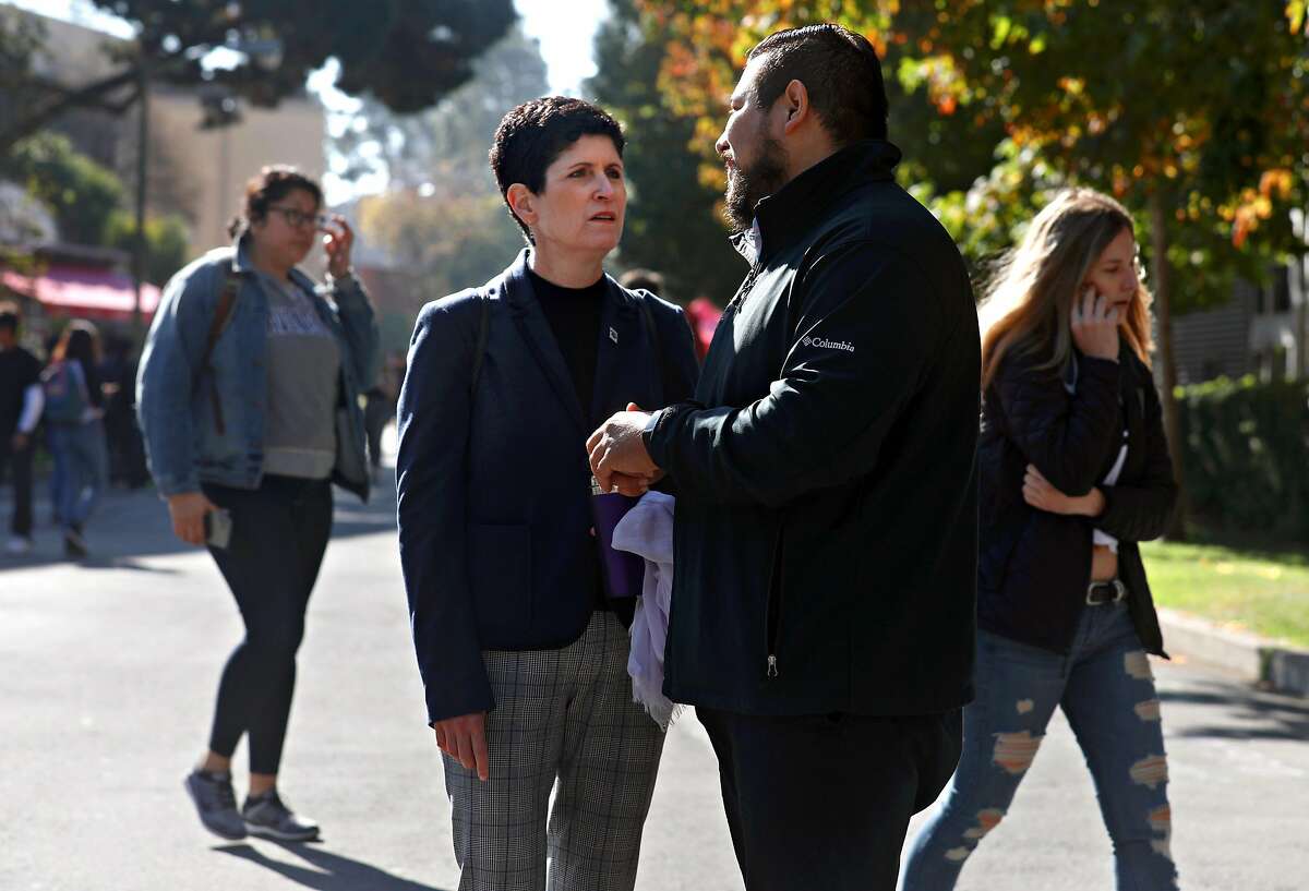 New San Francisco State University president Lynn Mahoney (left) takes a walk on campus with administrative support Luis De Paz Fernandez (right) on Monday, Nov. 4, 2019, in San Francisco, Calif.