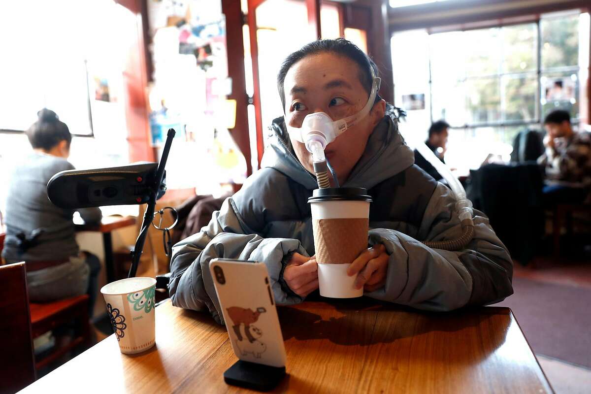 Alice Wong drlinks out of a paper cup at Atlas Cafe in San Francisco, Calif., on Wednesday, November 27, 2019. Wong, a disabled person and activist is fighting against the elimination of single use cups.