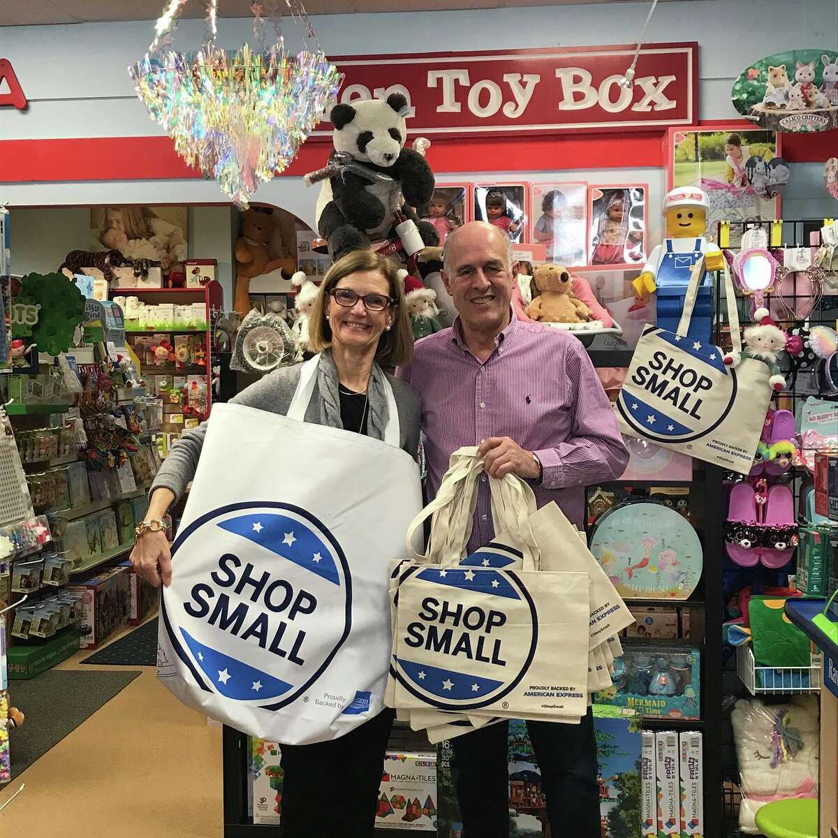 Darien Chamber of Commerce Executive Director Susan Cator and Darien Toy Box owner Bill Jensen prepare for Shop Small Saturday.