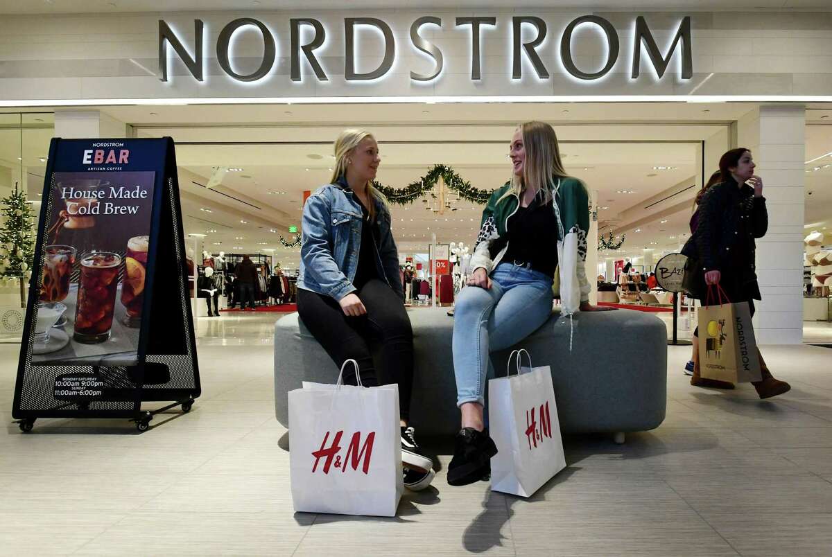 Shoppers Eleonore Freby and Annie Bjork take a break from searching for Black Friday deals at the SoNo Collection mall Friday, November 29, 2019, in Norwalk, Conn.