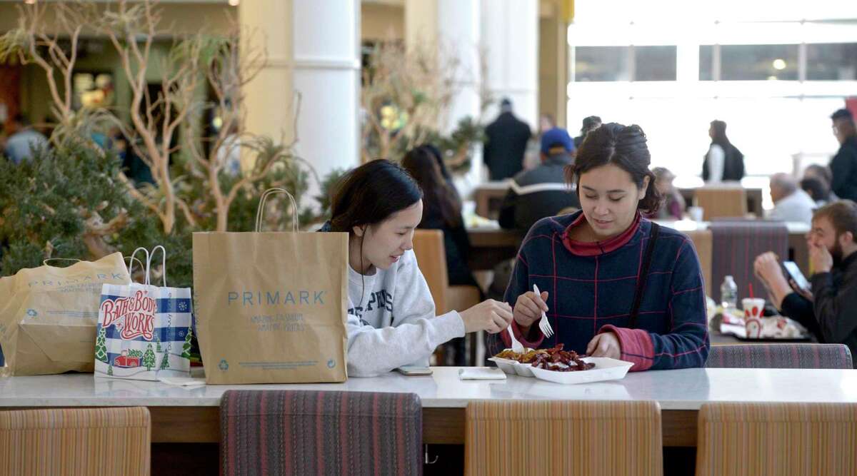 Julie Tobin, left, and Tanyon Estores, both of Newtown, stop to grab a late breakfast while Black Friday shopping at the Danbury Fair mall, on Friday, November 29, 2019, in Danbury, Conn. They had gotten to the mall around 8 AM to shop.