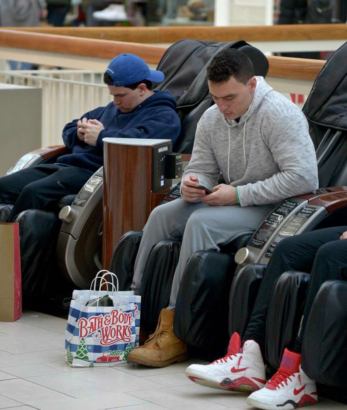 Stephen Conway, of Newtown, takes a break while Black Friday shopping at the Danbury Fair mall, Friday, November 29, 2019, in Danbury, Conn. Conway and friends got to the mall at 5:15 AM to do their shopping, a tradition which goes back five years.