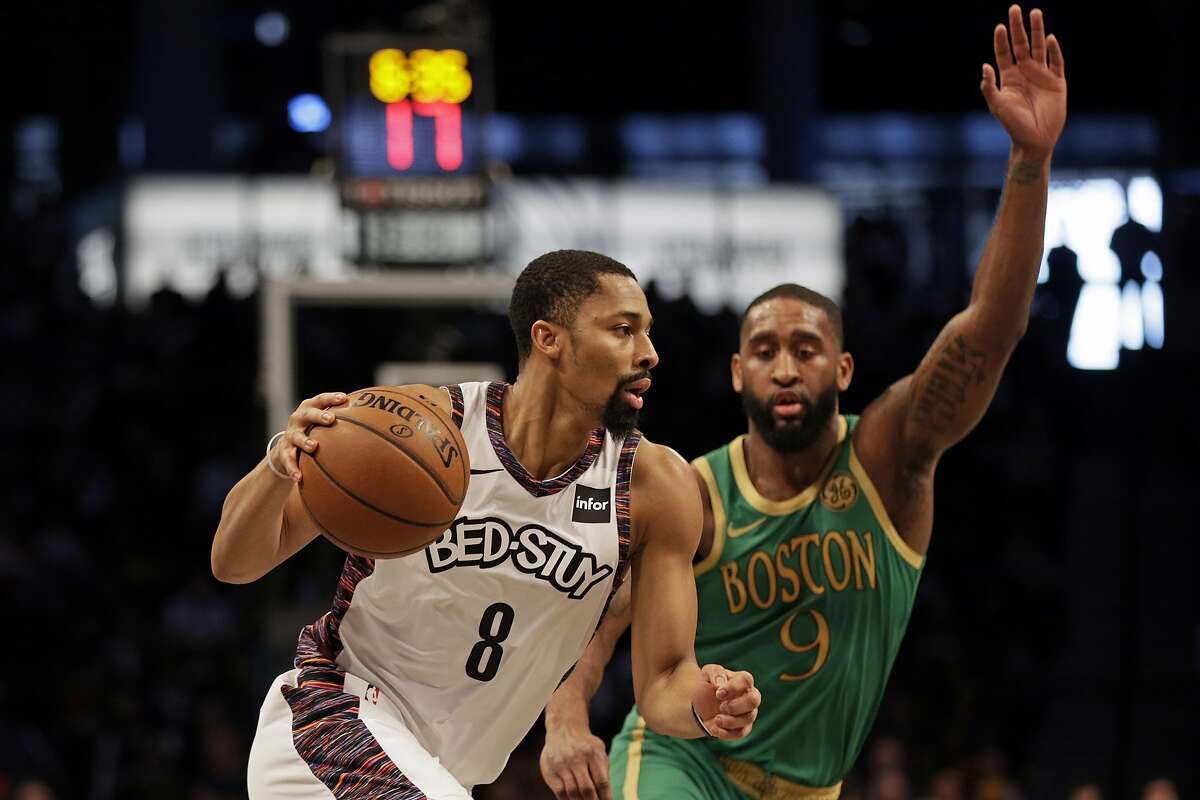 Brooklyn Nets guard Spencer Dinwiddie (8) drives to the basket past Boston Celtics guard Brad Wanamaker (9) during the first half of an NBA basketball game Friday, Nov. 29, 2019, in New York. The Nets won 112-107.