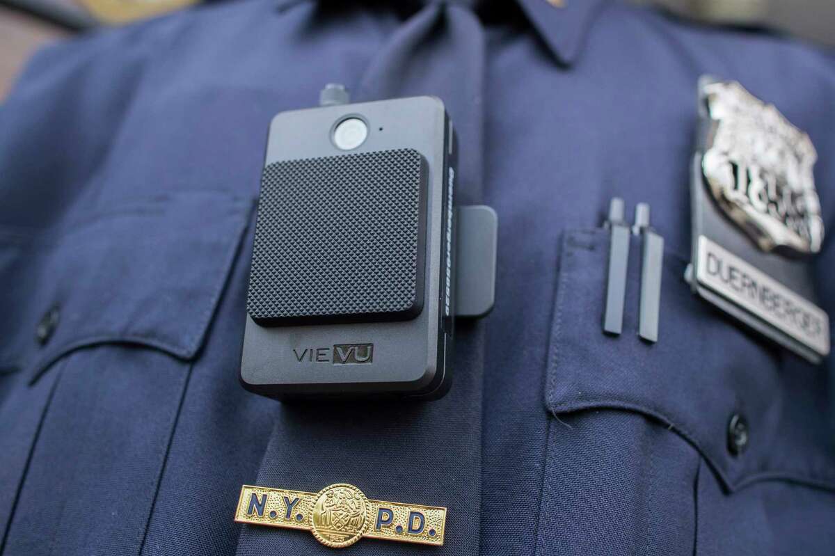 FILE - In this April 27, 2017 file photo, a police officer wears a newly-issued body camera in New York. Some lawmakers are proposing to equip state troopers with body cameras in New York, one of few states where the primary law enforcement agency doesnat have body or dashboard cameras already. The New York state police force is the largest among them. (AP Photo/Mary Altaffer, File)