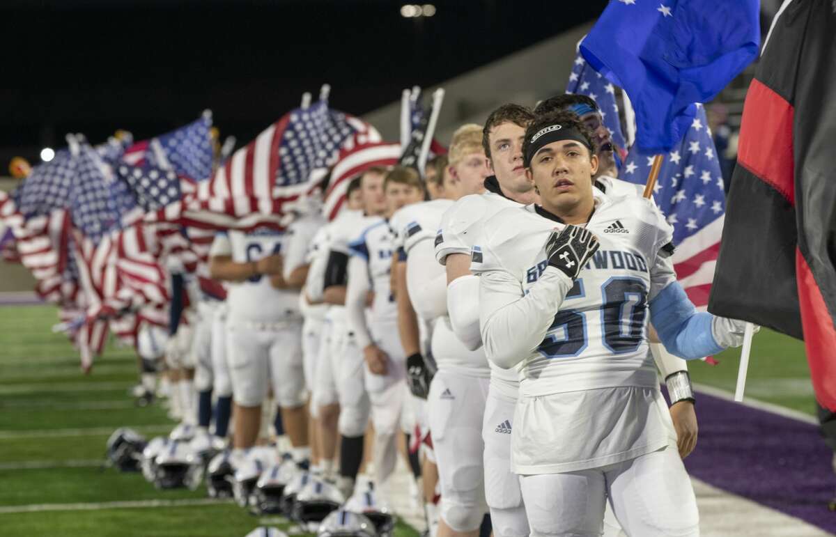 Greenwood line up holding American Flags as well as Service Flags during the National Anthem 11/29/19 during the playoff game against Lubbock Estacado at Anthony Field on the campus of Abilene Christian University. Tim Fischer/Reporter-Telegram