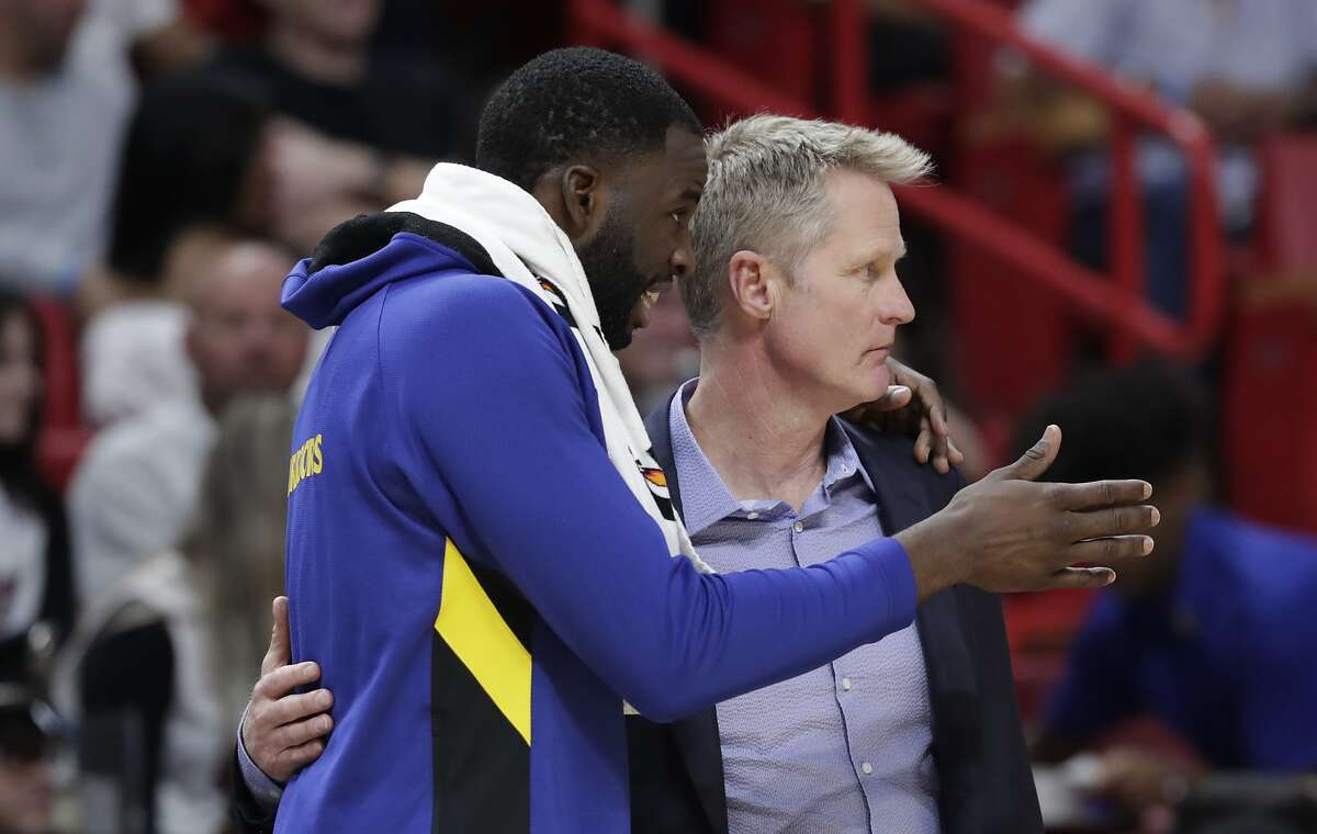 Golden State Warriors forward Draymond Green, left, talks with head coach Steve Kerr during the second half of an NBA basketball game against the Miami Heat, Friday, Nov. 29, 2019, in Miami. (AP Photo/Lynne Sladky)